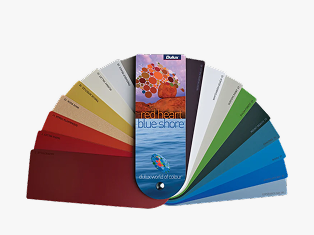 White and neutral themed living room with couch and buffet table against wall with decorative items.